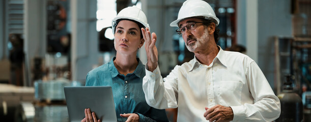 Factory manager or executive with assistant make visit factory tour and inspect heavy steel industrial machinery showcase leadership quality as inspection supervisor engineer. Panorama Exemplifying