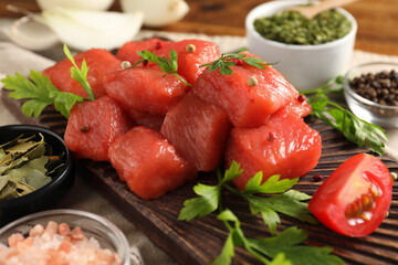 Raw beef meat and different ingredients for cooking delicious goulash on table, closeup