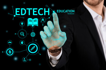 Man using virtual screen with text EDTECH on dark background