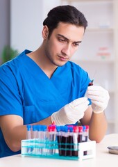 Young lab assistant testing blood samples in hospital