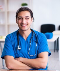 Young male doctor looking at x-ray images