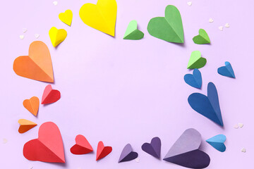 Frame made of colorful paper hearts on lilac background. LGBT concept