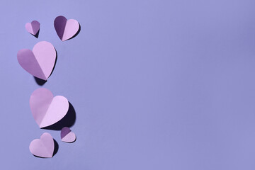 Composition with paper hearts on lilac background. Valentines Day celebration