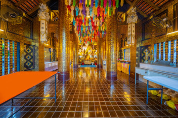 Fototapeta na wymiar Beautiful Wat Buddhist temples in Chiangmai Chiang mai Thailand. Decorated in beautiful ornate colours of red and Gold and Blue. Lovely sunset