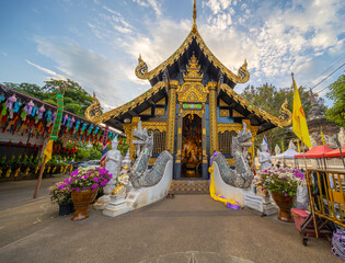Beautiful Wat Buddhist temples in Chiangmai Chiang mai Thailand. Decorated in beautiful ornate colours of red and Gold and Blue. Lovely sunset - obrazy, fototapety, plakaty