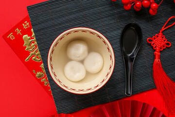 Bowl of tangyuan and Chinese decor on red background. Dongzhi Festival