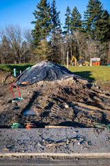 Freshly dug up ground and in progress installation of underground utilities on a new residential...