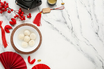 Bowl of tangyuan, Chinese decor and fortune cookies on white marble background. Dongzhi Festival