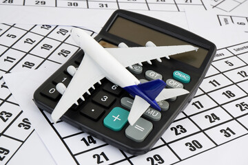 Airplane tickets price, travel budget, flight schedule concept. Airplane model and calculator on...