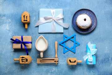 Composition with traditional symbols and gifts for Hanukkah celebration on color background