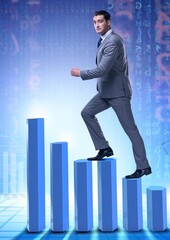 Businessman climbing bar charts in business concept