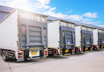 Container Trucks on The Parking Lot at Warehouse. Lifting Ramp Trucks. Commercial Truck Transport Lorry. Shipping Delivery Trucks. Distribution Warehouse. Freight Truck Logistics Cargo Transport