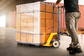 Workers Unloading Package Boxes on Pallet in Warehouse. Hand Pallet Truck Loader. Delivery Service. Supply Chain Shipment Goods. Distribution Supplies Warehouse Logistics