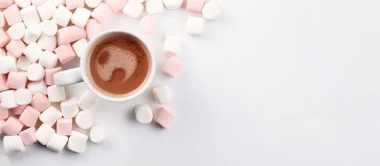  Mug of hot cocoa with marshmallows, seen from above, on white background. © 2rogan