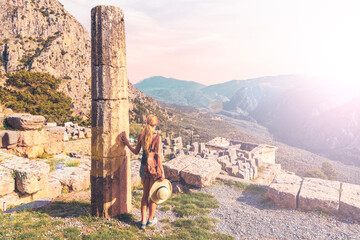 Ancient city of Delfi, ruins of temple of Apollo, Theatre and female tourist- Travel, tour tourism...
