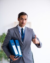 Young male accountant working in the office