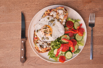 top view of Egg and mushrooms on toast served with fresh salad on table 