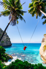 Young woman tourist on Bali swing at Diamond beach at Nusa Penida island Bali, Indonesia - 687392479