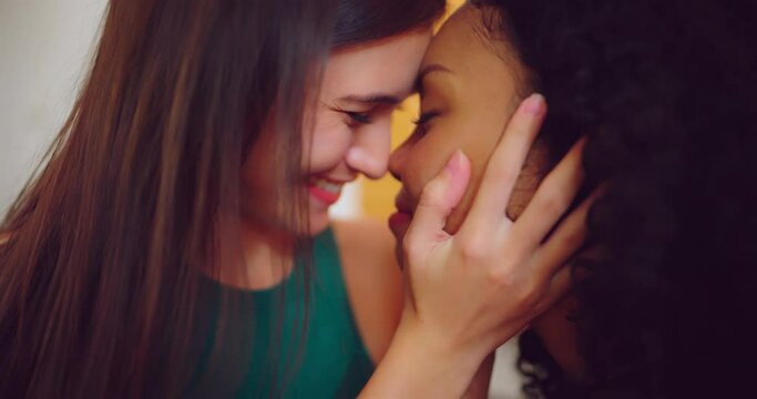 Young couple lesbian having happy moment in living room. They kissing each other with happy expression at home