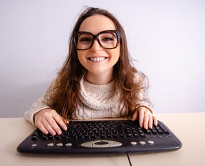 Funny nerd girl working on computer