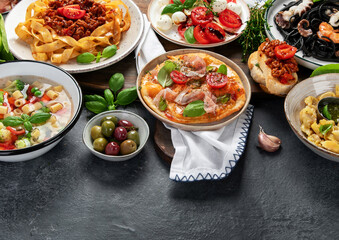 Italian food dishes on dark background. Traditional food concept.