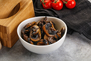 Roasted champignon mushrooms in the bowl