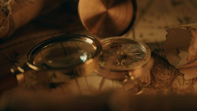 Compass and magnifier on a old vintage world map with countries and continents. Retro style. Concept of geography or global history and cartography. Wars of conquest and navigation. 4K ProRes