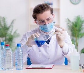 Young male chemist experimenting in lab