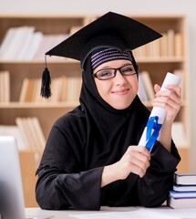 Muslim girl in hijab studying preparing for exams