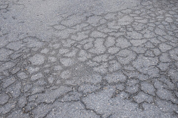 Asphalt pavement that has been cracked from use over a period of time - Powered by Adobe