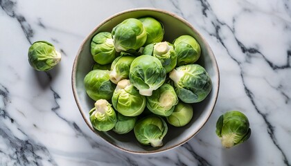 Top view of a brussels sprouts in a solid white marble background; copy space