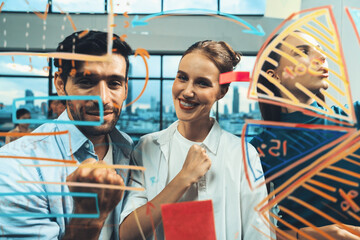 Portrait of happy business team celebrate their successful project at glass wall. Group of professional confidence businesspeople smiling while standing at financial statistic chart. Closeup. Tracery.