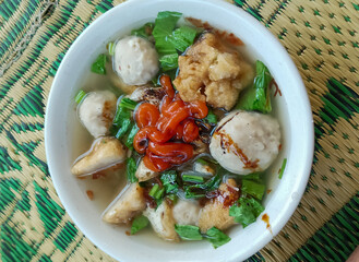 A bowl of meatball food, taken at close range