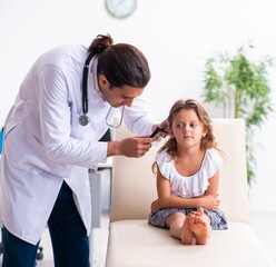 Young doctor pediatrician with small girl