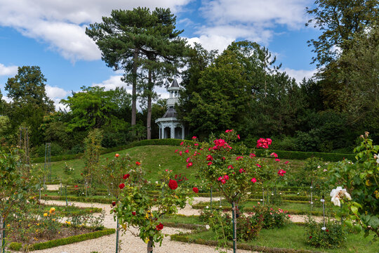 Rose garden in the Bagatelle park with empress kiosk in the background. It is located in Boulogne-Billancourt near Paris, France