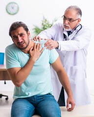 Injured young man visiting old doctor