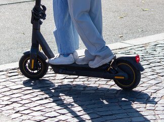Two people ride a scooter in the city © schankz
