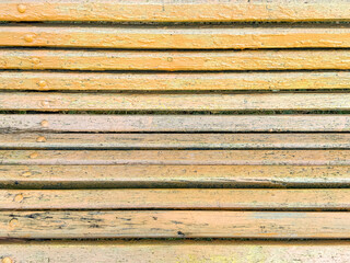 Yellow wooden boards on a bench as an abstract background. Texture