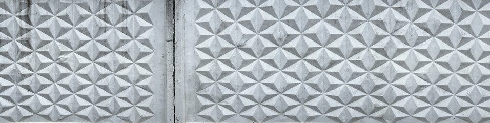 Patterned white concrete fence as background. Texture
