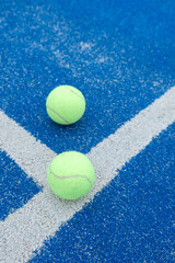blue paddle tennis court and balls, racket sports courts concept