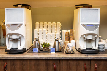 Modern Self-Service Coffee Station with Cups and Fresh Milk Options in hotel