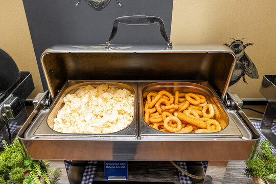 Breakfast Buffet Array with Scrambled Eggs and Curly Fries in Chafing Dishes in hotel