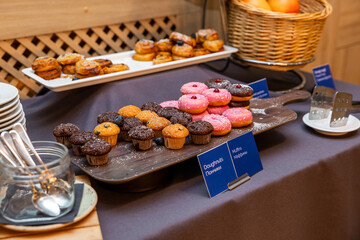 Delicious Breakfast Spread with Donuts, Muffins, and Freshly Baked Pastries on a Buffet Table in hotel