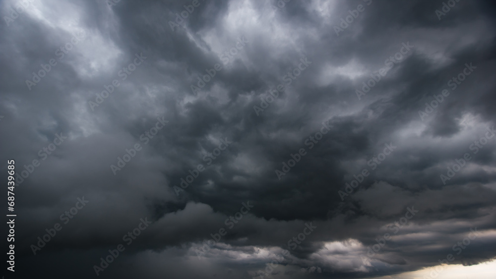 Poster the dark sky with heavy clouds converging and a violent storm before the rain.bad or moody weather s