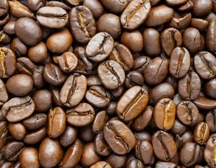 Fototapeta premium Close up of a bunch of coffee beans background top view; roasted dark brown coffe seeds