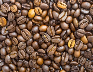 Close up of a bunch of coffee beans background top view; roasted dark brown coffe seeds
