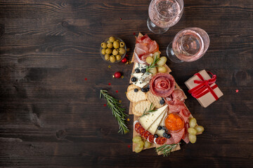 Charcuterie board italian food antipasti prosciutto ham, salami and cheese appetizers served in the...