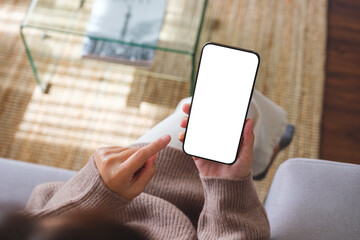Top view mockup image of a woman holding mobile phone with blank desktop white screen - obrazy, fototapety, plakaty