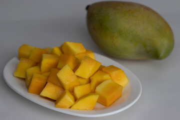 Fresh large totapuri mangoes sliced to small pieces, juicy and vibrant in color