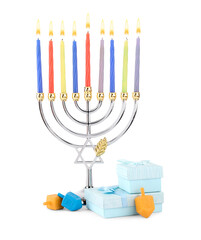 Hanukkah celebration. Menorah with candles, gift boxes and colorful dreidels isolated on white